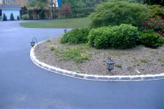 Landesign-Hardscape-Masonry-Valley-Forge-Cobblestone-in-cement-edging-around-a-driveway