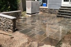 Landesign-Hardscape-Masonry-Valley-Forge-Flagstone-Patio-with-a-stone-staircase-and-stone-seating-wall