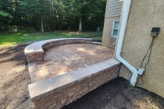 Landesign-Hardscape-Masonry-Valley-Forge-stone-wall-with-patio-and-lighting-2-scaled