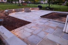 Landesign-Hardscape-Masonry-Valley-Forge-stone-wall-with-patio-and-lighting-scaled