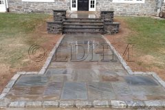 Landesign-Hardscape-Masonry-Valley-Forge-IShinier-Finish-Flagstone-walk-in-concrete-with-steps-and-columns-bordered-on-Belgian-Block.-Haverford-PA